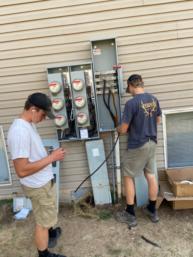 Electricians upgrade an electrical service panel