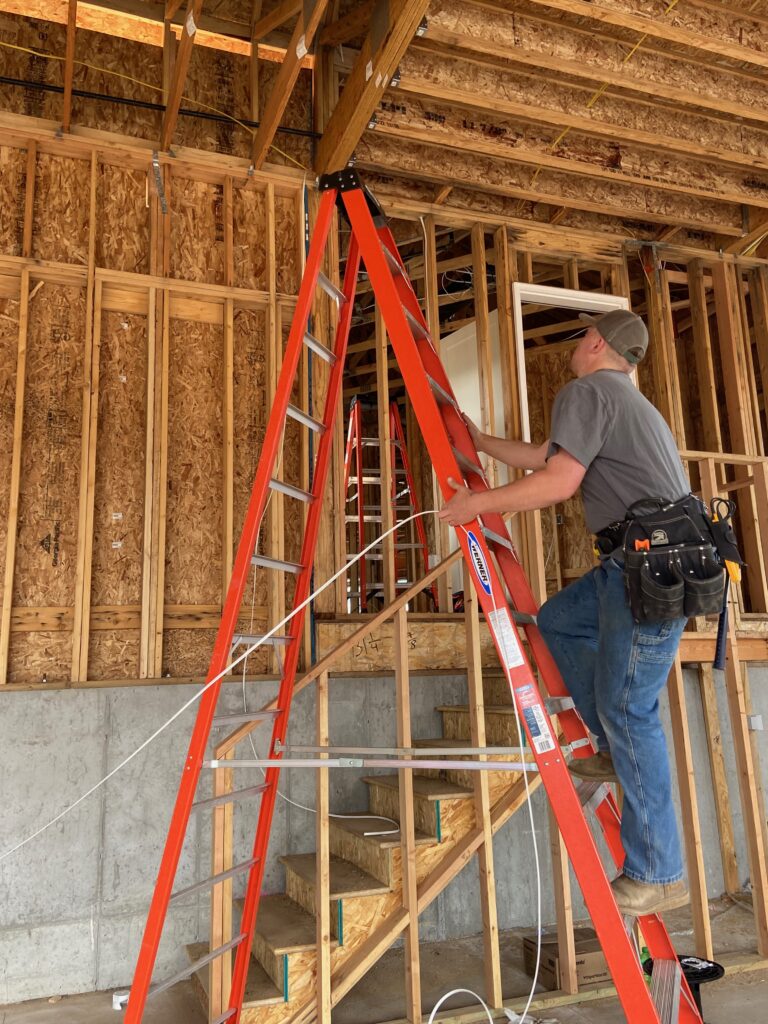 Utah electrician climbing a ladder