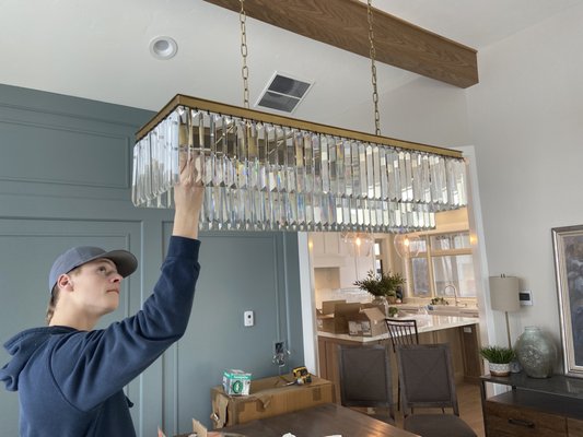 Utah electrician hanging a light fixture
